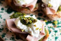 Pistachio-Crusted Mortadella and Burrata Crostini