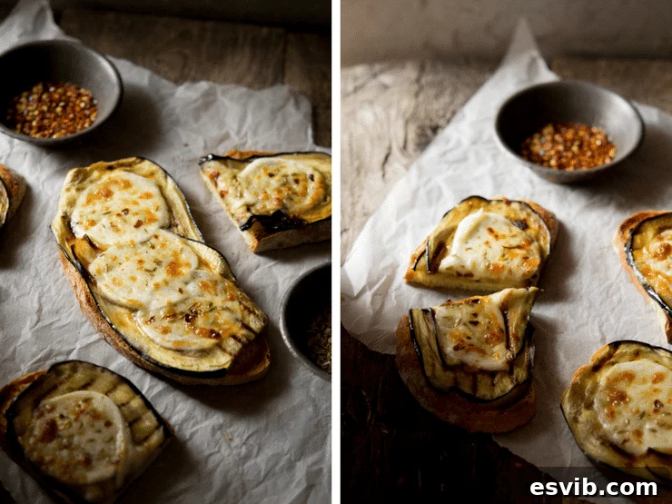 A close up of eggplant bruschetta with mozzarella sitting on crushed baking paper on a wooden surface