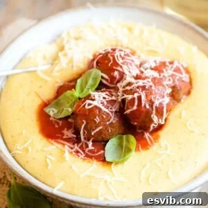A close up of eggplant meatballs on top of polenta
