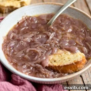 A close up of Carabaccia Tuscan onion soup in a bowl, ready to be enjoyed.