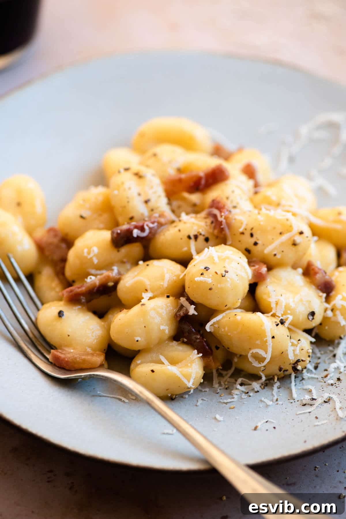 Pillowy Gnocchi Carbonara 6 A close up of Gnocchi Carbonara on a plate, showing the creamy sauce and crispy guanciale bits.