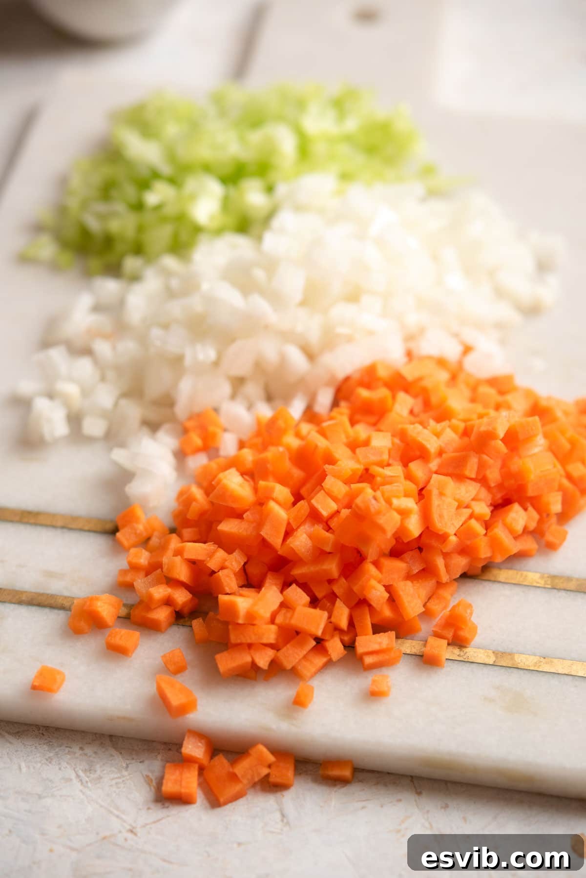 The Art of Perfect Soffritto 5 A close up of finely chopped soffritto gently sautéing in olive oil in a pan, turning translucent but not browned