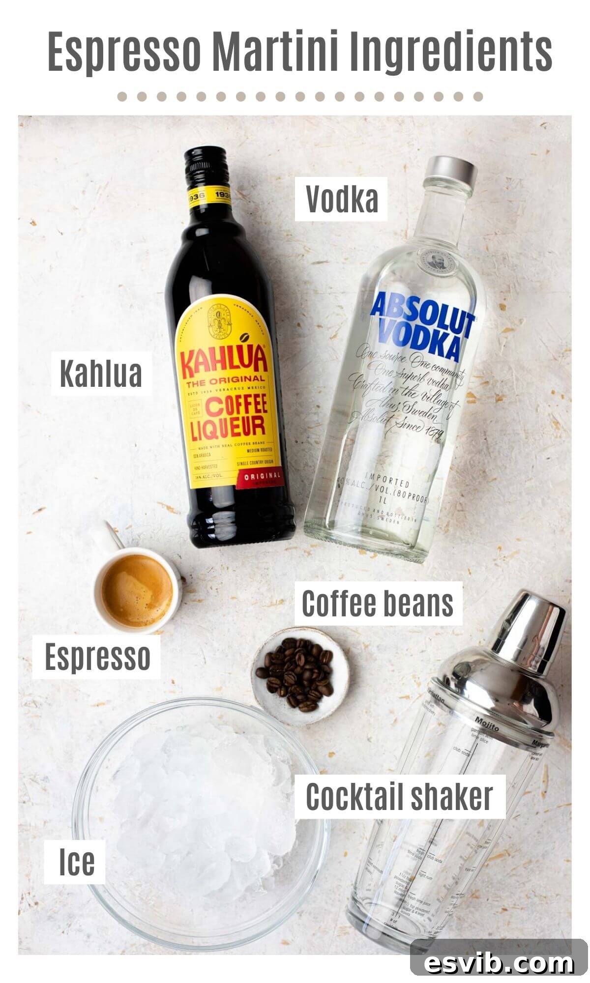 An overhead shot showcasing all the fresh, high-quality ingredients laid out for making an Espresso Martini, including vodka, Kahlúa, espresso, and coffee beans.