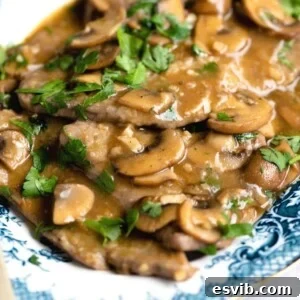 A close up of veal marsala on a blue servings plate
