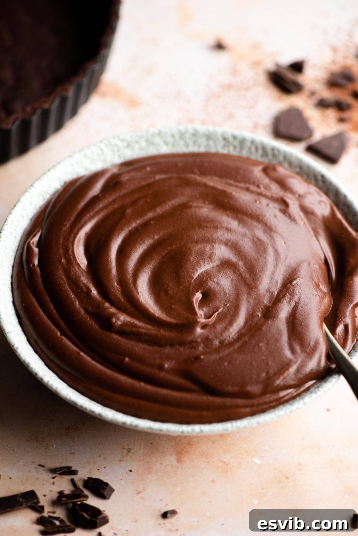A close-up of a bowl filled with rich, smooth Chocolate Pastry Cream, inviting a spoonful