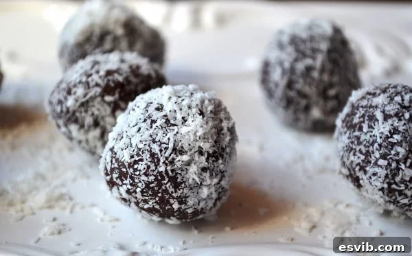 Various dark chocolate avocado truffles coated in coconut and cocoa powder.