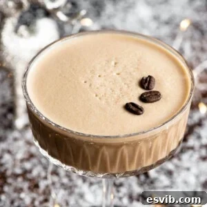 A close up of a Martini Macchiato cocktail in a glass topped with coffee beans, invitingly presented.