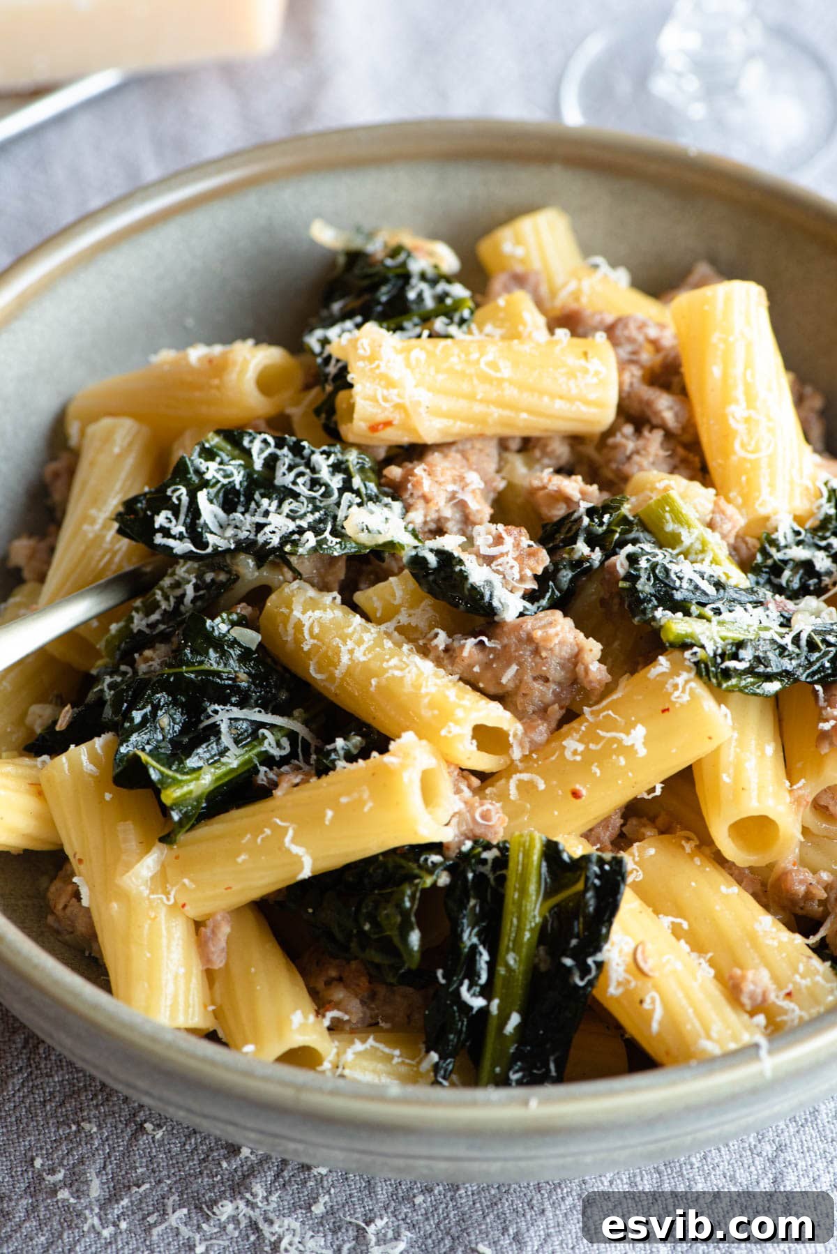 A close up of rigatoni pasta with sausage and cavolo nero
