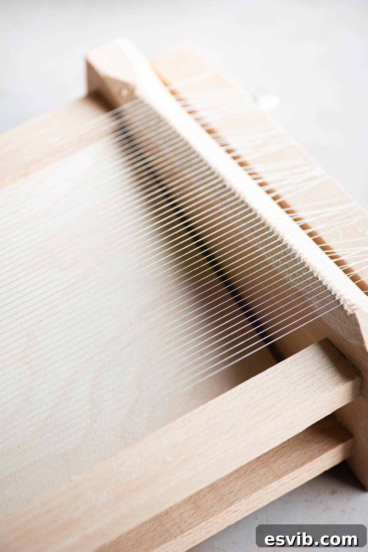 Homemade Tonnarelli Pasta 4 A close-up view of La Chitarra, the traditional Italian pasta cutting tool, showcasing its strings and wooden frame.