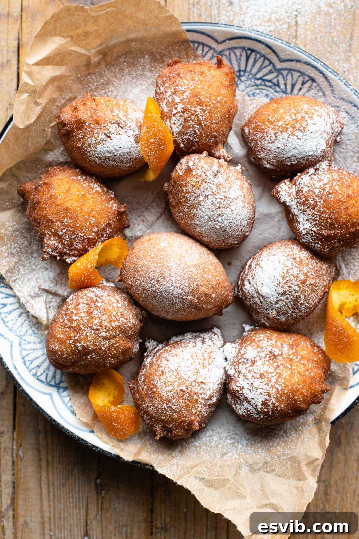 Sweet Italian Ricotta Puffs 2 An overhead shot of small ricotta doughnuts on a plate dusted with powdered sugar