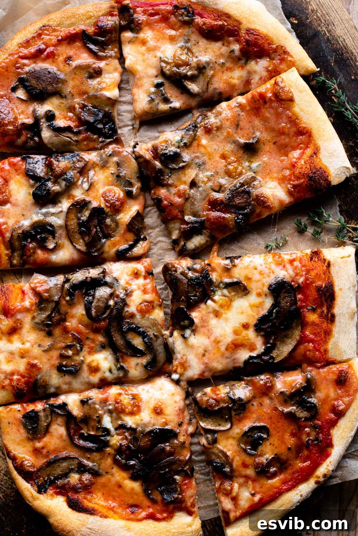 Creamy Taleggio Wild Mushroom Pizza 2 An overhead shot of a freshly baked Taleggio and Mushroom Pizza, perfectly cut into 8 inviting slices, showcasing the golden crust and melted cheese.