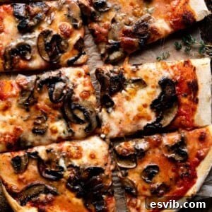 A close-up cropped image of a mushroom pizza cut into slices, showcasing its delightful textures and rich cheeses.
