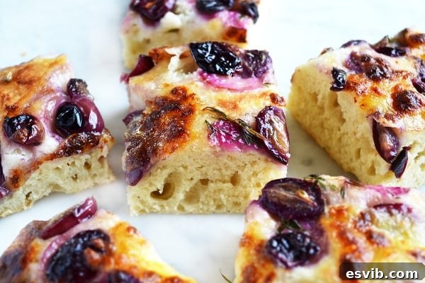 red grape and mozzarella focaccia, fresh out of the oven, topped with vibrant grapes and melted cheese