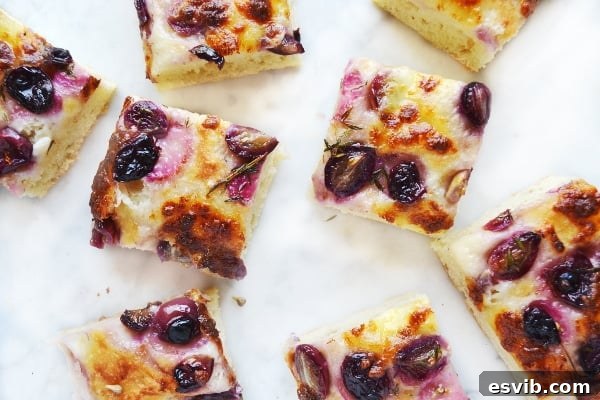 close-up of red grape and mozzarella focaccia, showcasing the fluffy interior and golden crust