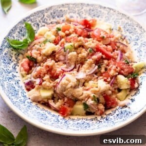 A cropped image of Panzanella salad in a blue bowl.