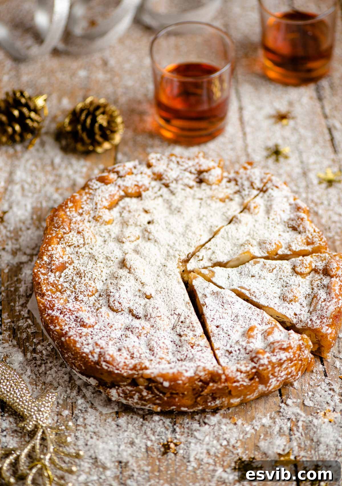 Slices of traditional Panforte arranged beautifully on a wooden table, adorned with festive Christmas decorations, creating a warm and inviting scene.
