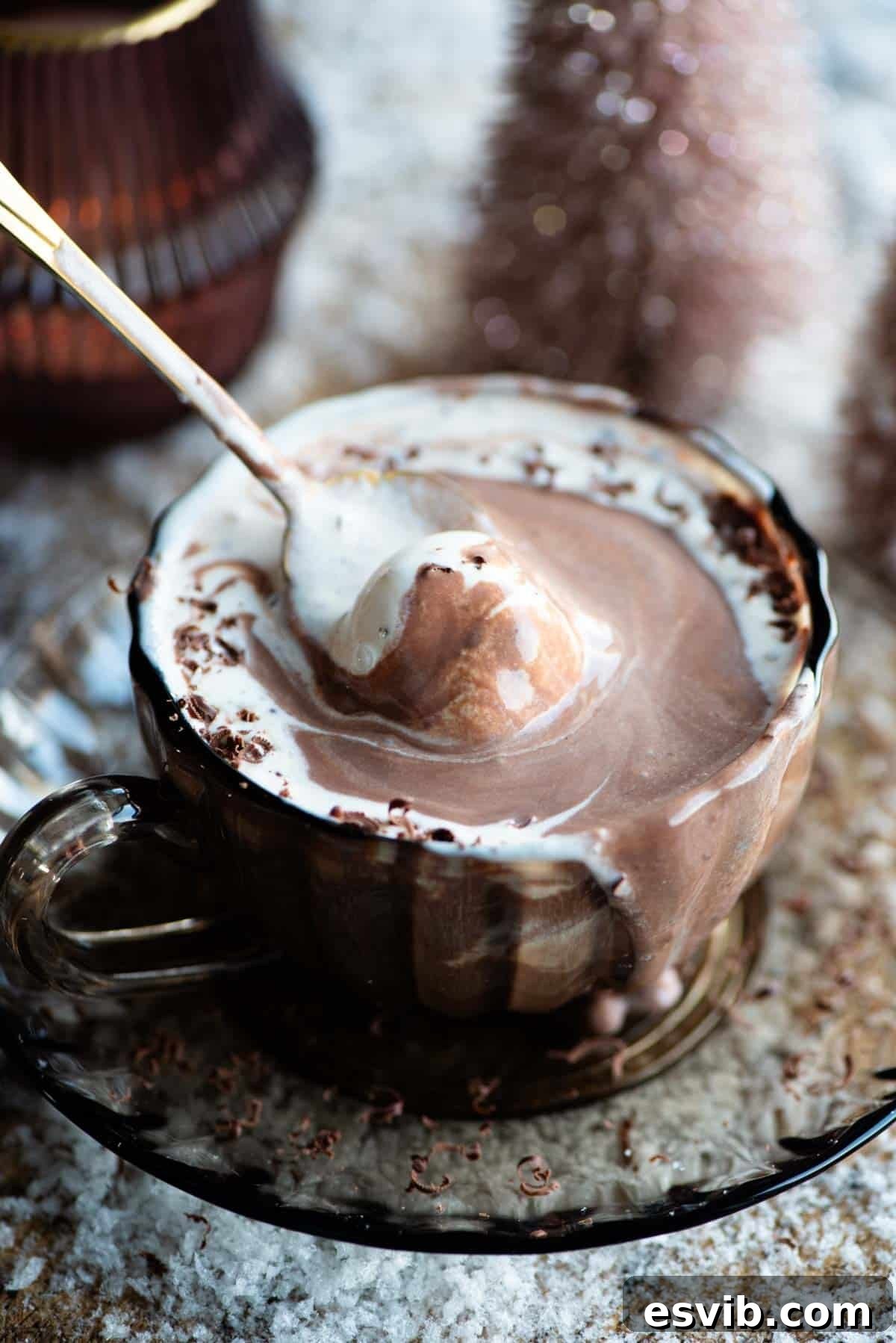 Decadent Frangelico Hot Chocolate Affogato 5 A close-up shot of a Hot Chocolate Affogato with a spoon gently scooping up the melted vanilla ice cream and rich chocolate, showcasing its creamy texture and inviting appearance.