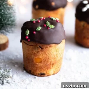 A close up of a mini Panettone topped with melted chocolate and Christmas sprinkles.