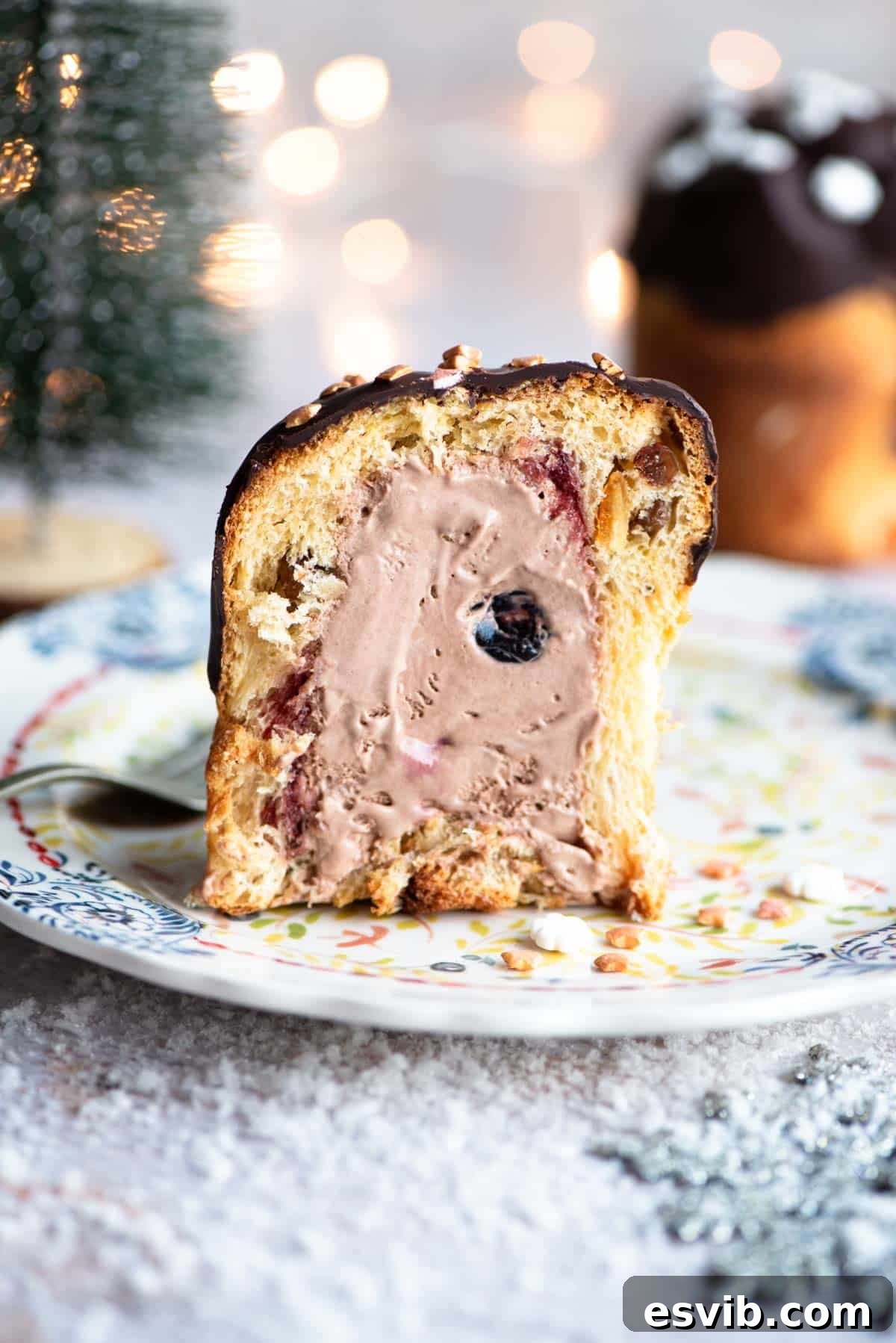 A mini Panettone cut in half showing it beautifully stuffed with layers of cherry and chocolate ice cream, ready to be enjoyed.