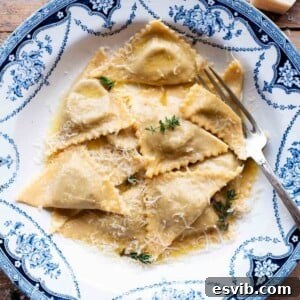 A cropped image of delicate triangoli pasta resting in a blue patterned bowl, ready to be served.