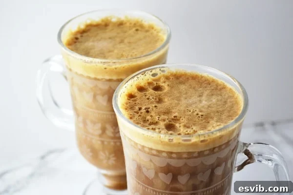 Two Servings of Homemade Banana Milk Coffee Two glasses of inviting banana milk coffee side by side on a pristine white surface, ready to be enjoyed.