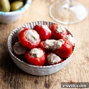 A close up of delicious tuna stuffed cherry peppers in a small dish.