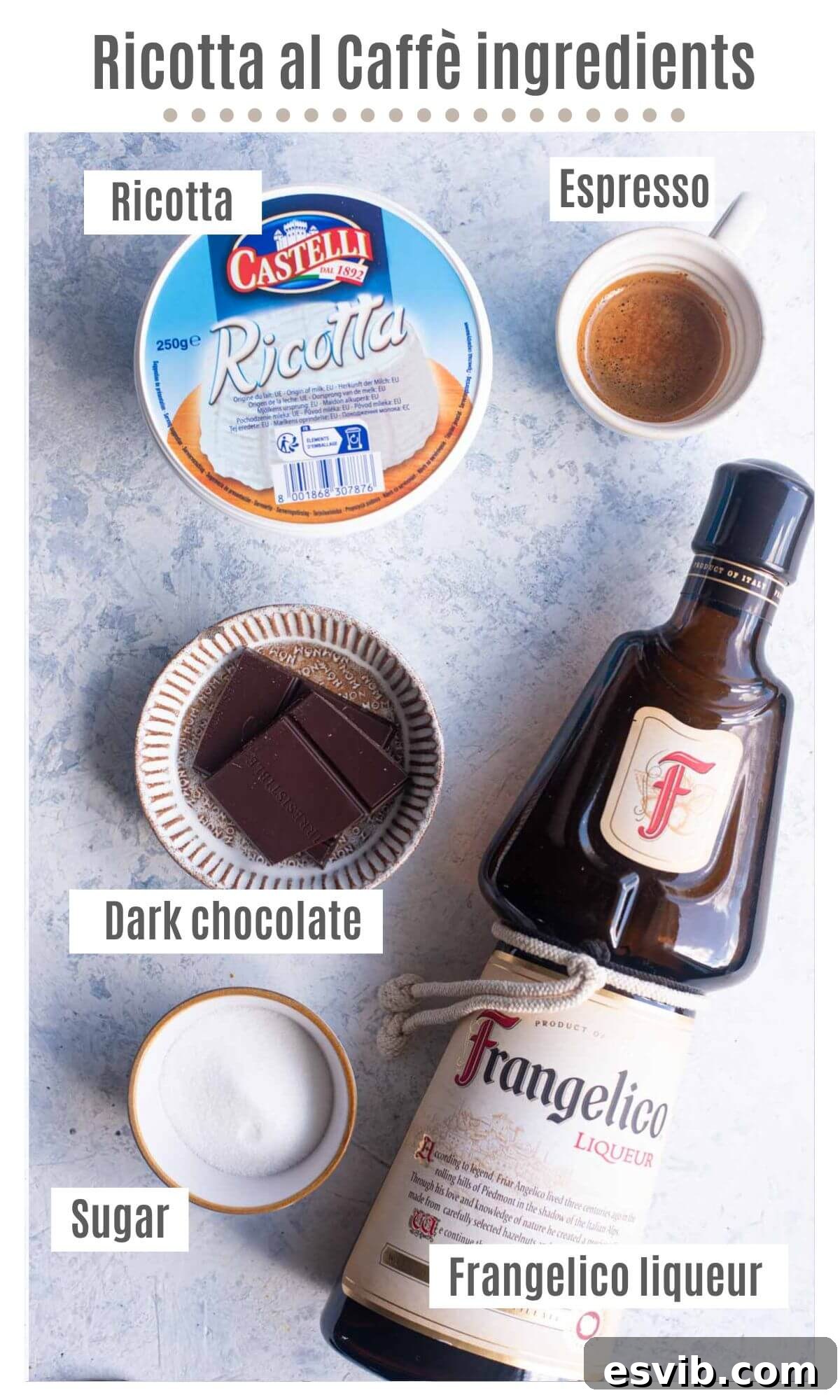 An overhead flat lay shot displaying all the key ingredients needed to prepare Ricotta al Caffè: a tub of ricotta cheese, a small glass of espresso, a bowl of caster sugar, a bottle of Frangelico liqueur, and a bar of dark chocolate.