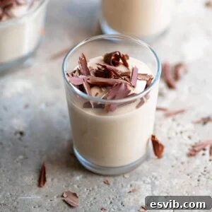A close-up photograph of creamy Ricotta al Caffè artfully arranged in a small glass.