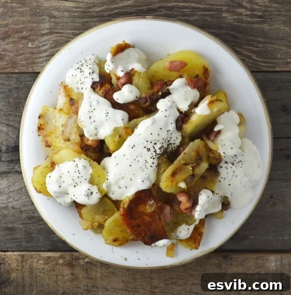 Bratkartoffeln, crispy fried potatoes with smoked pancetta and sweet white onion topped with an incredible garlic and herb sauce. It's SO GOOD! Insidetherustickitchen.com Bratkartoffeln, crispy fried potatoes with smoked pancetta and sweet white onion topped with an incredible garlic and herb sauce. It's SO GOOD! Insidetherustickitchen.com