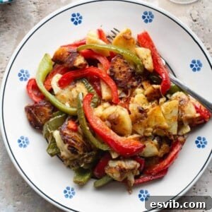 Calabrian Pepper Potato Medley 6 A cropped overhead shot of perfectly cooked potatoes and peppers on a traditional Italian painted terracotta plate.