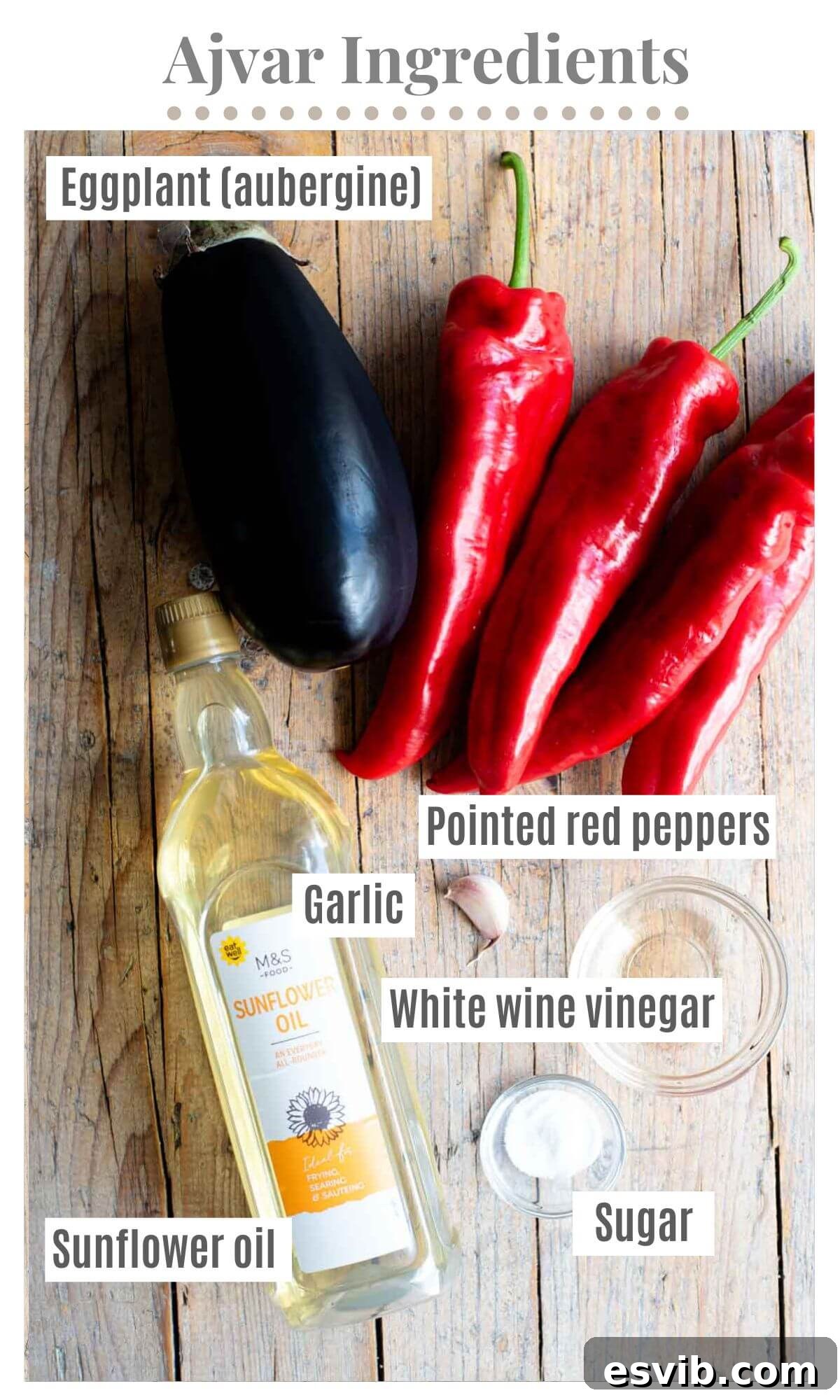 Ajvar: Smoky Roasted Red Pepper Spread 3 An overhead shot of all the fresh ingredients needed to make Ajvar dip: pointed red peppers, a large eggplant, a garlic clove, sunflower oil, white wine vinegar, and sugar.