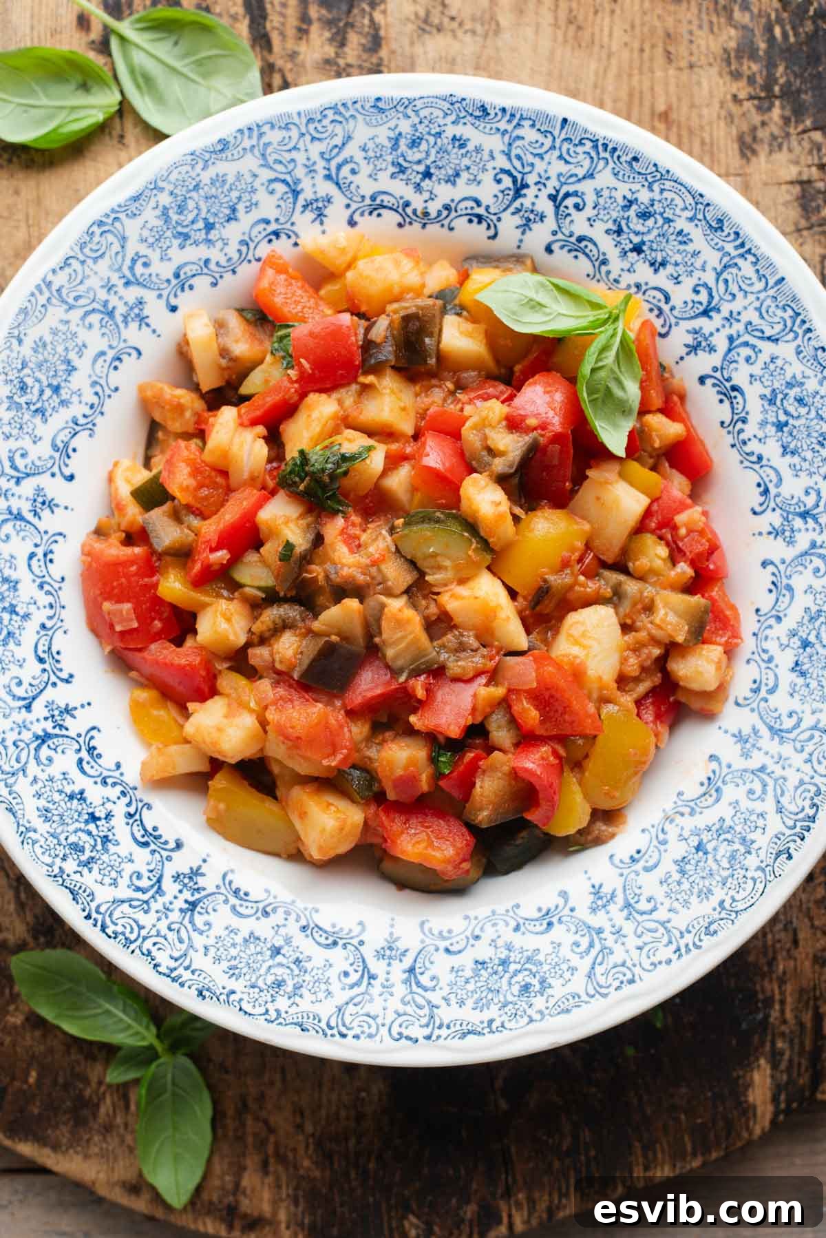 Ciambotta Vibrant Summer Vegetable Medley 2 An overhead shot of Ciambotta (Italian vegetable stew) in a blue bowl, the background is wooden.