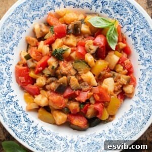 Ciambotta Vibrant Summer Vegetable Medley 7 An overhead cropped image of Ciambotta Italian summer stew in a blue and white bowl.