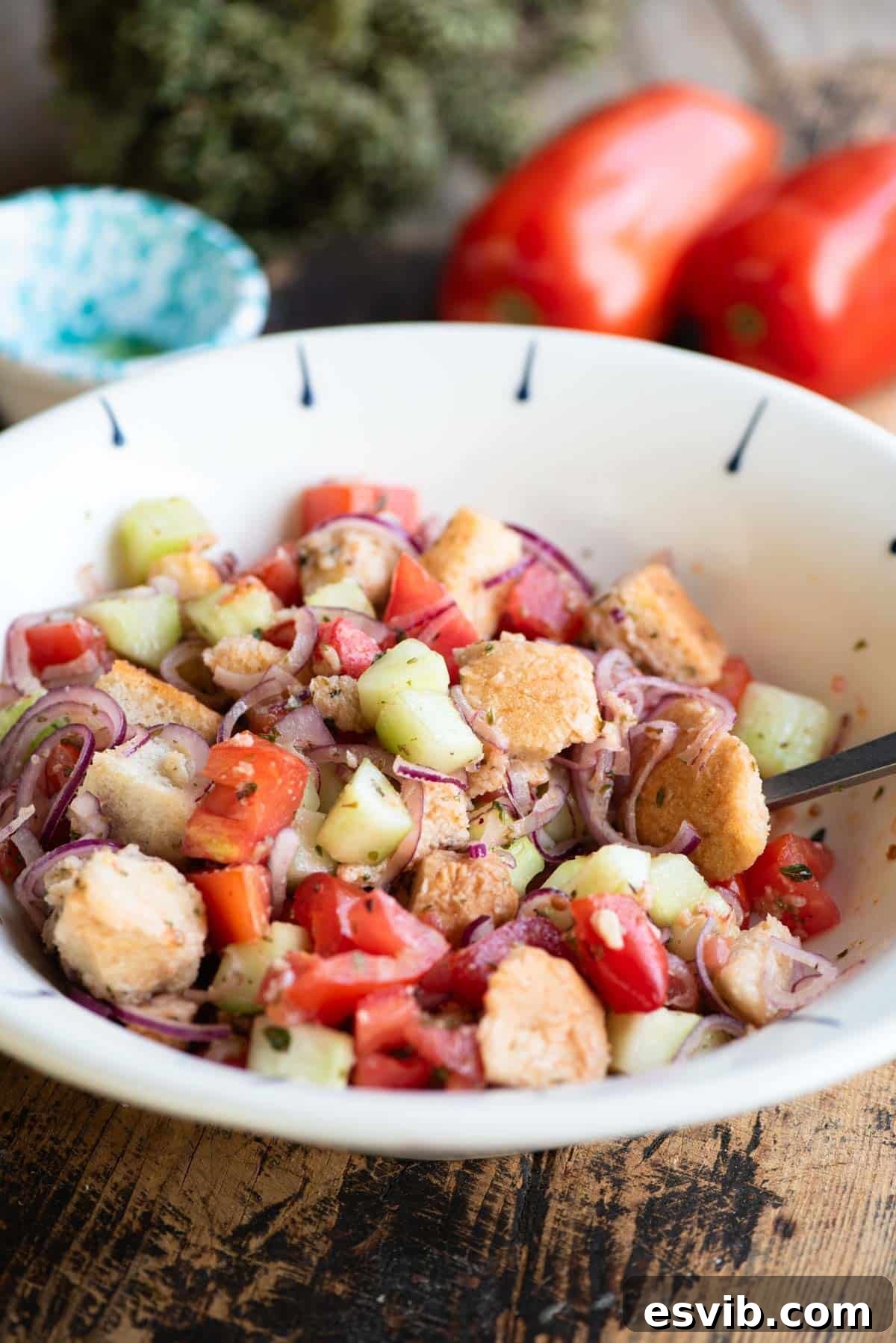 Cialledda salad in a white bowl sitting on a wooden surface.