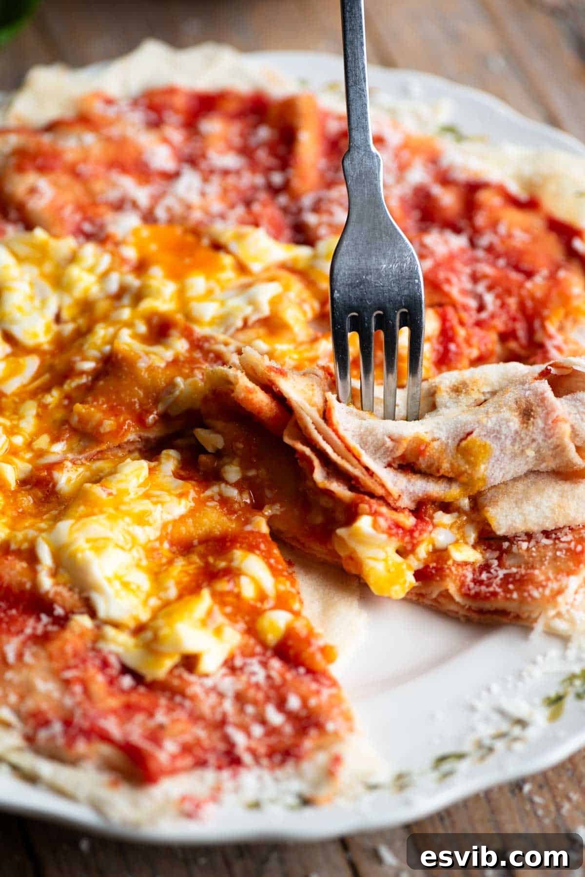 A fork cutting into a piece of pane frattau.