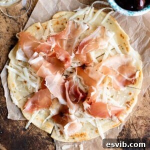 Brustengo: Umbria's Rustic Flatbread 7 A close up cropped image of Brustengo, an Italian flatbread topped with meat and cheese.
