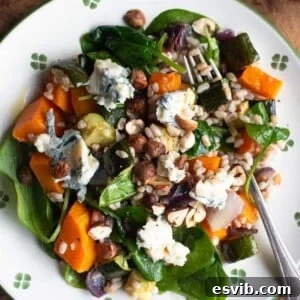 An overhead close up of a butternut squash and farro salad, highlighting its freshness and appeal.