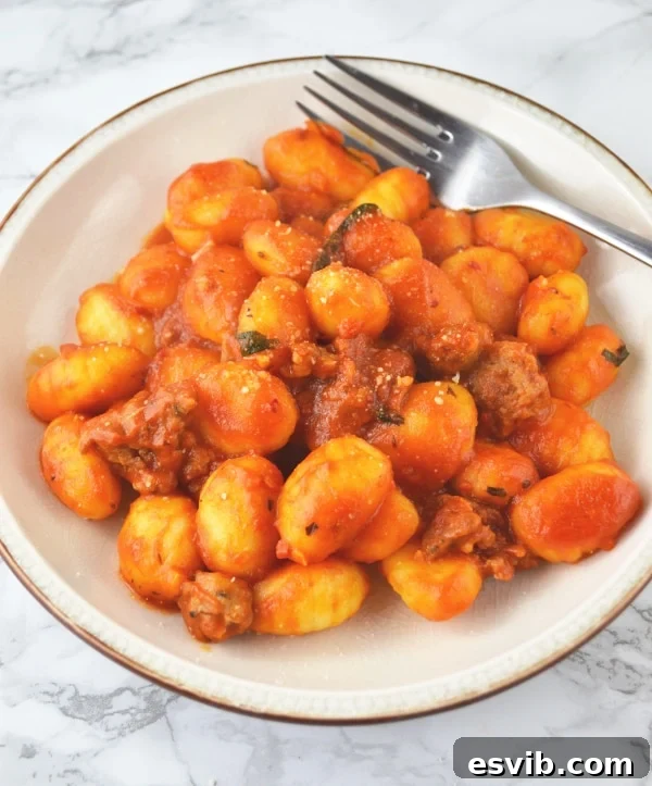 Close-up of Gnocchi coated in a rich, spicy tomato and Nduja sauce in a serving bowl, ready to be enjoyed.