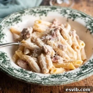 Close-up of a rustic bowl of Pasta alla Norcina, rich with creamy sauce and golden sausage.
