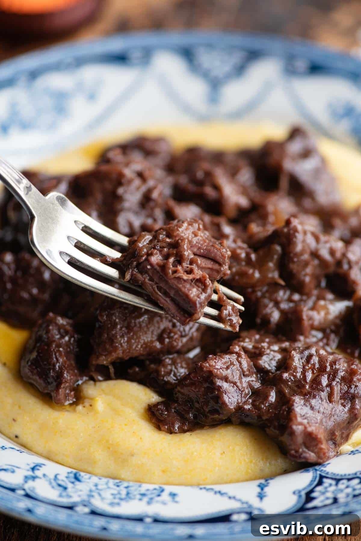 A close up of Italian beef stew on a fork.
