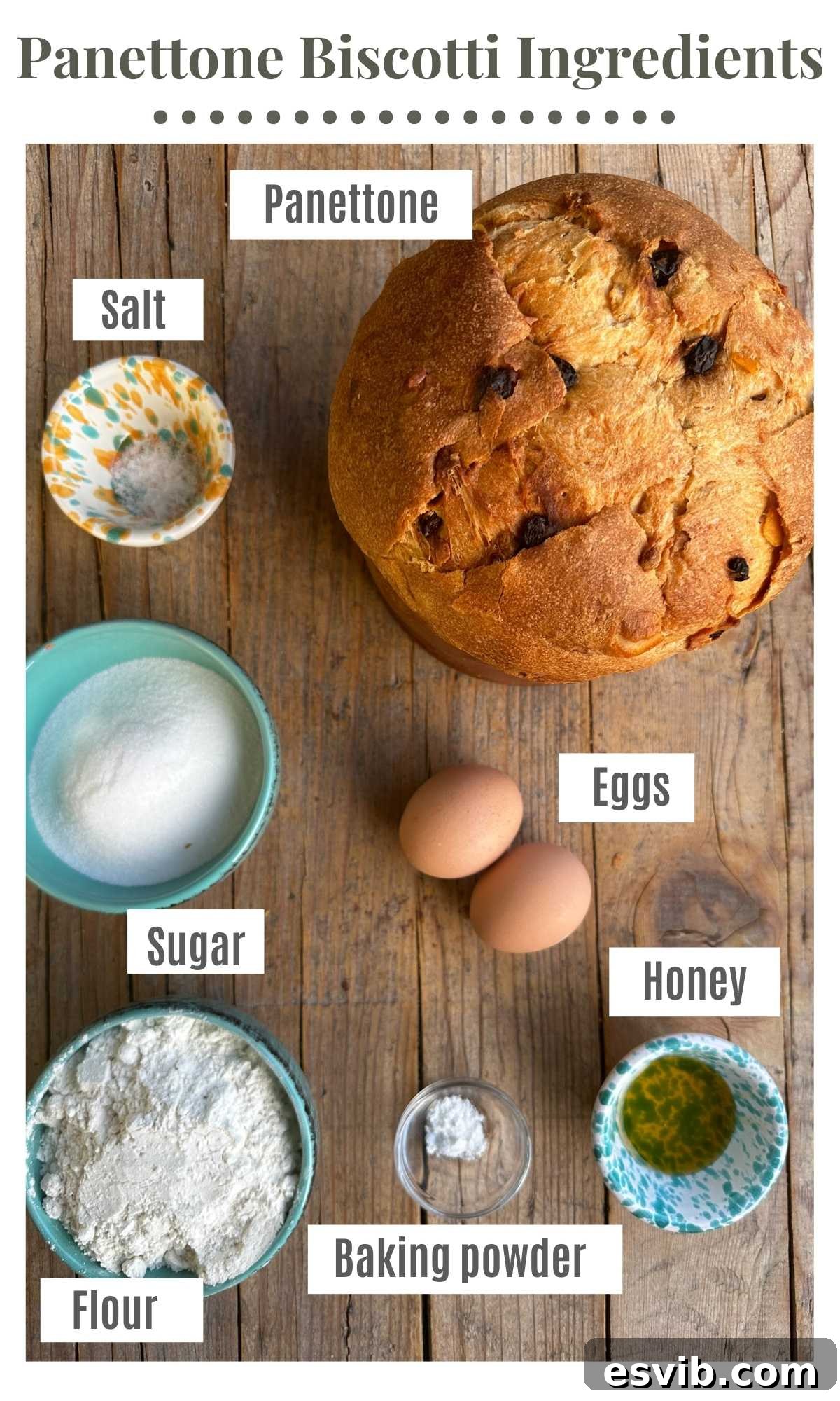 An overhead shot of all the ingredients needed to make Panettone Biscotti, including flour, sugar, eggs, honey, and torn panettone pieces.