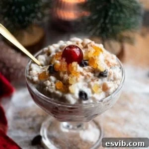 Cuccia The Sicilian Ricotta Delight 8 A close up of Cuccia, a Sicilian ricotta dessert in a small glass bowl topped with candied fruit.