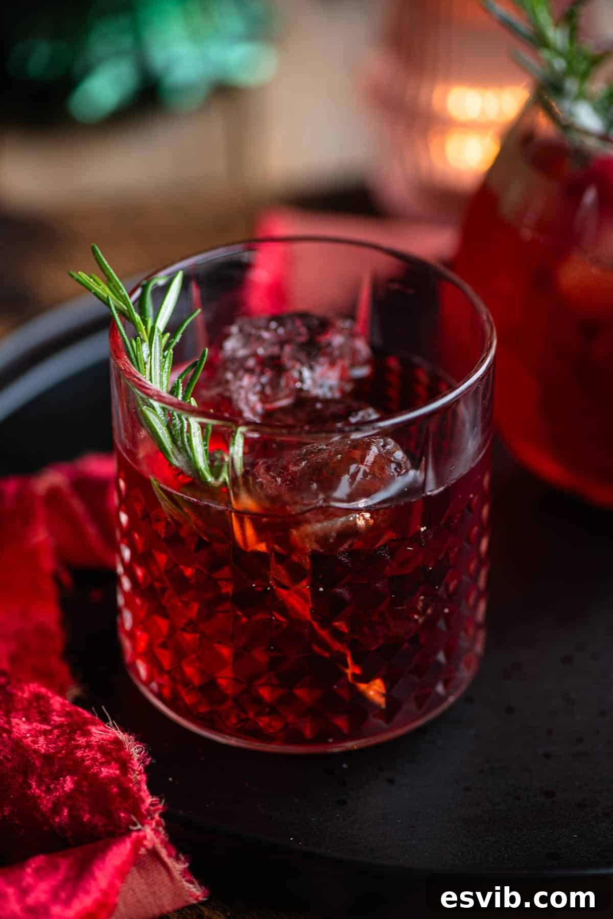 Scarlet Serendipity 5 A detailed close-up of The Sbagliato Rosso cocktail, highlighting its rich red color and the delicate garnish of a rosemary sprig in a cocktail glass.
