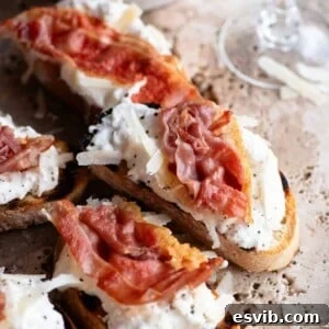 A serving of Burrata, Parmigiano, & Crispy Prosciutto Crostini, garnished and ready to enjoy.
