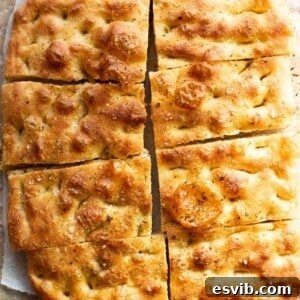Golden, rustic and bubbly focaccia cut into 8 slices.