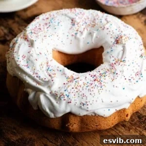 A close-up shot of an Italian Easter bundt cake, Ciaramicola, elegantly topped with meringue and colorful sprinkles.
