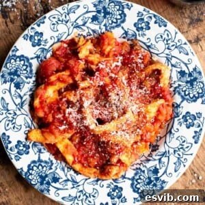 Trippa finta in a blue and white bowl sitting on a wooden surface.