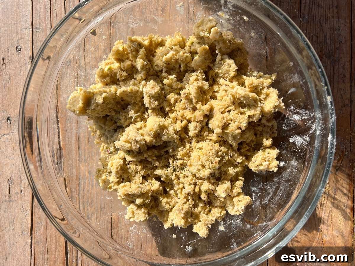 Pastry dough in a rough crumb texture in a glass bowl.