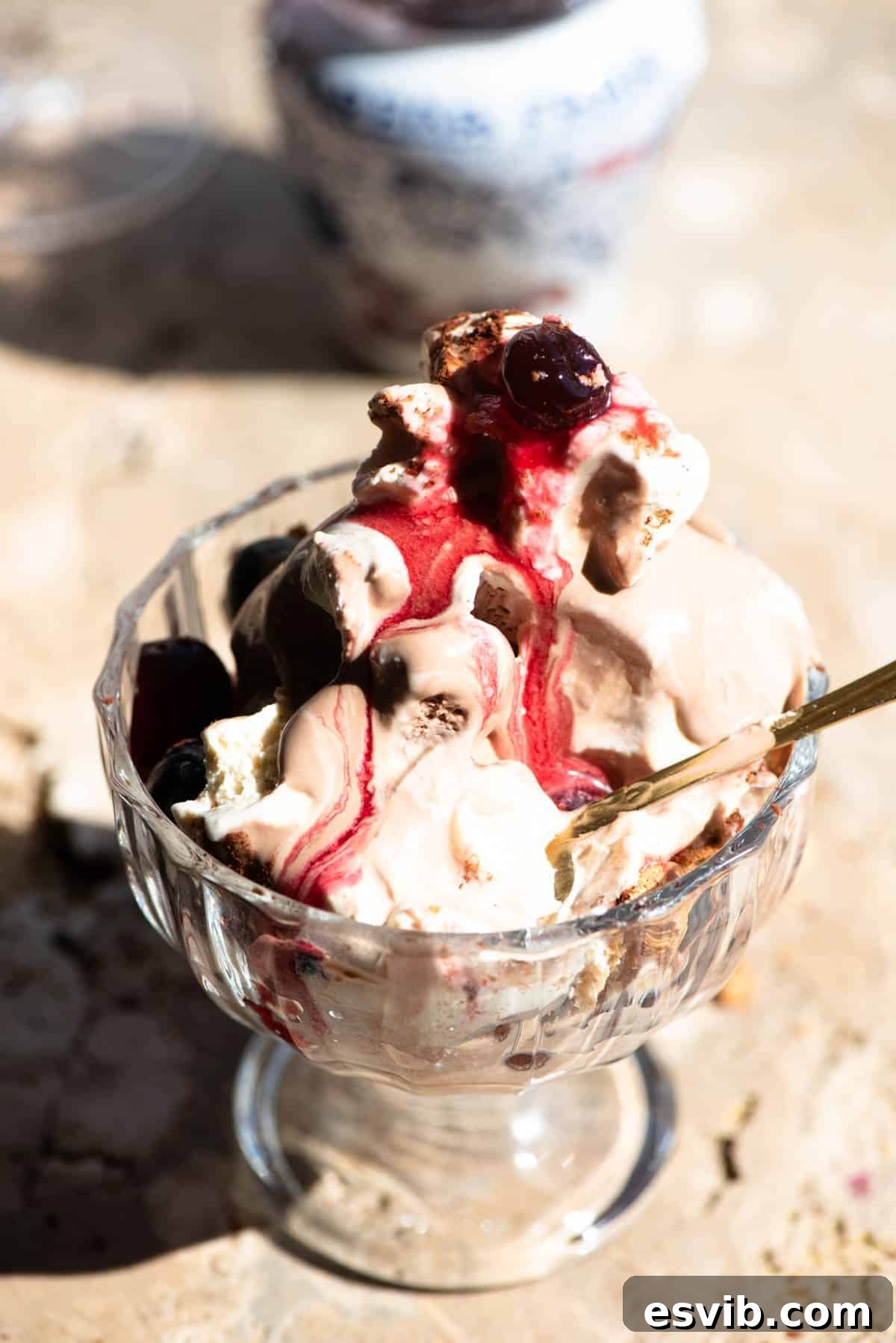 Paciugo: Liguria's Frozen Fantasy 4 A close-up photograph of an Italian ice cream sundae, showing its luscious layers and rich textures, slightly melting in a clear glass bowl, garnished with succulent Amarena cherries.