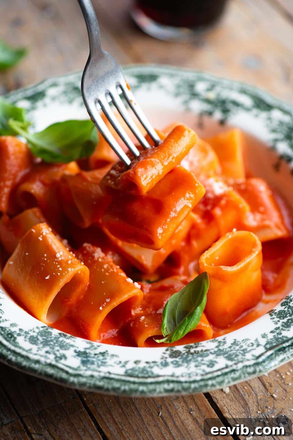 Vittorio's Silky Tomato Butter Paccheri 6 A close-up shot capturing a fork expertly twirling and lifting Paccheri pasta, generously coated in the rich, smooth tomato sauce, highlighting its perfect texture and appetizing appeal.